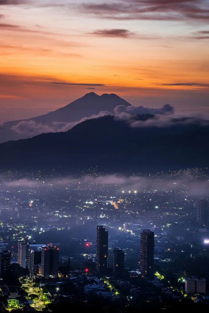 San Salvador skyline at dusk beneath the volcano — home of the DLT Law
