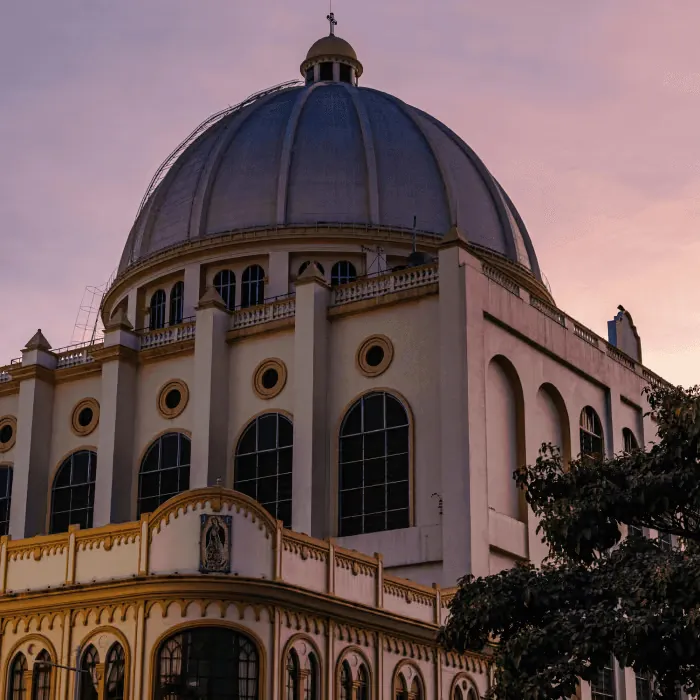 Historic domed building in El Salvador at sunset